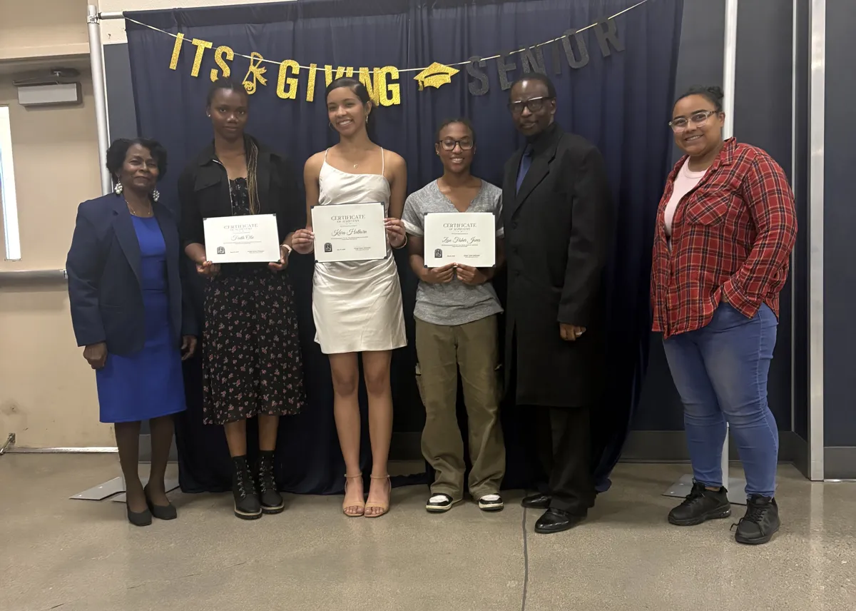 Ameni with students holding certificates